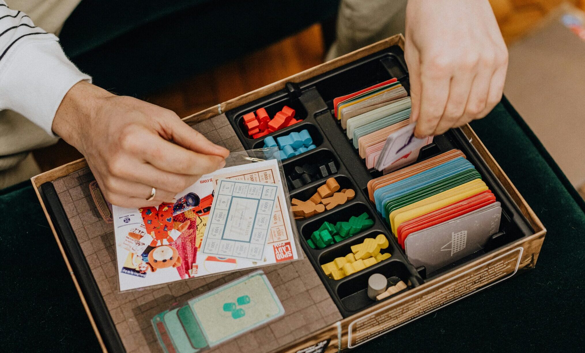 Close-up of a board game setup being organized for a fun leisure activity.